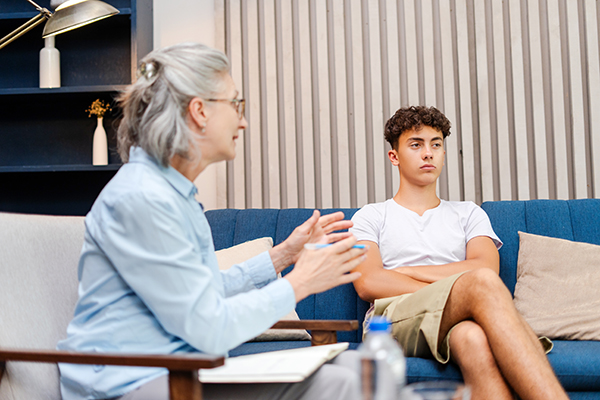 Psychologist listening to her teenage patient talking about problems